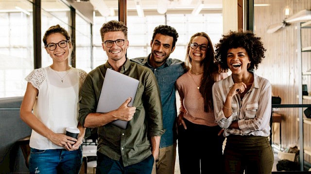 diverse group of happy co-workers at a startup company with a thriving organizational culture